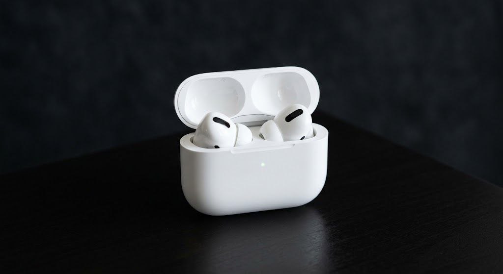 Apple AirPods Pro in white charging case on clean dark background showcasing sleek wireless design